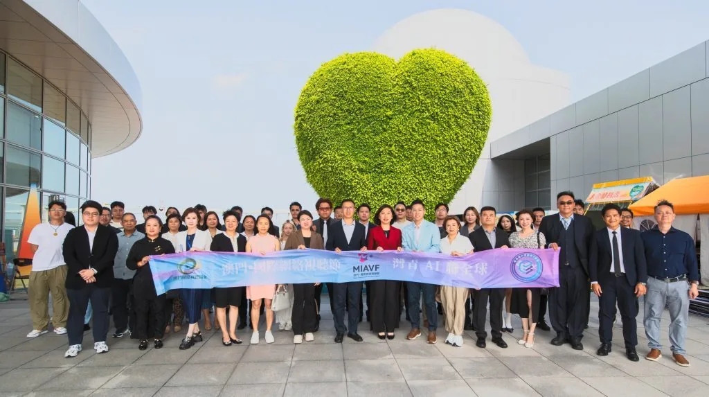 Sean Own and council members with Bay Youth AI banner in front of the Macao landmark