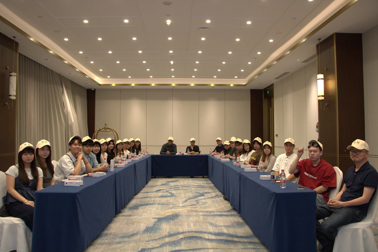 Delegation briefing in a U-shaped meeting room at the Hangzhou host venue